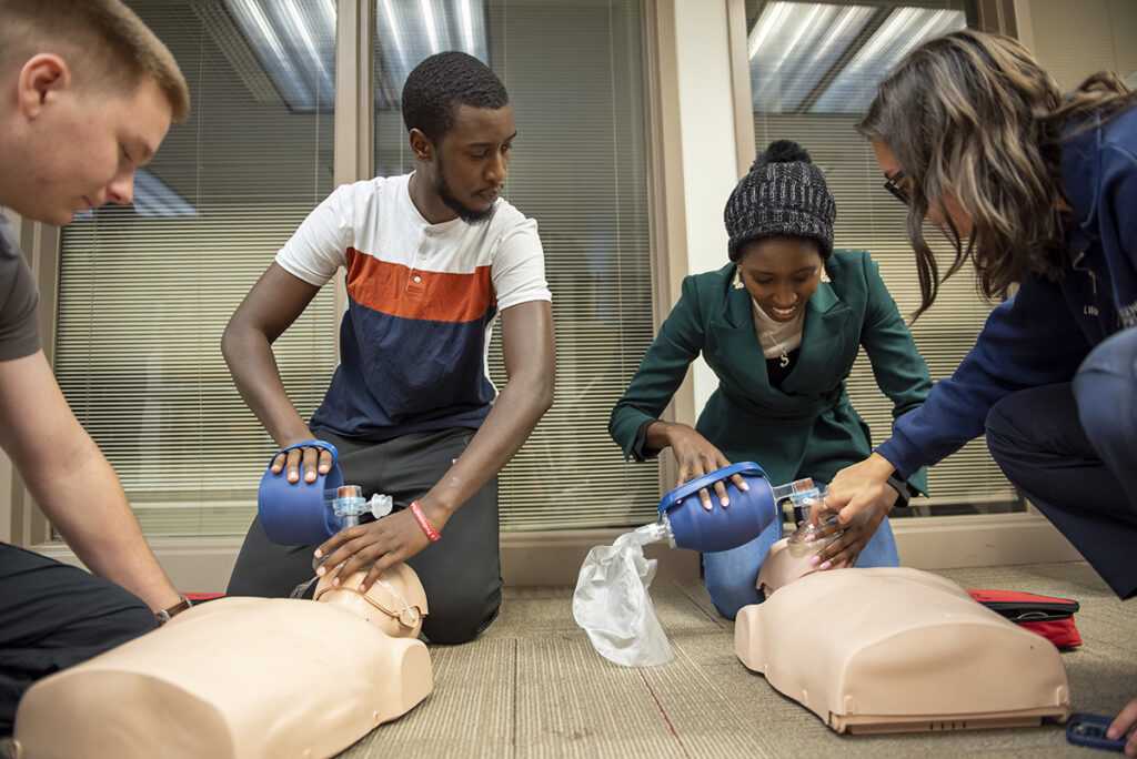 Two students practice CPR