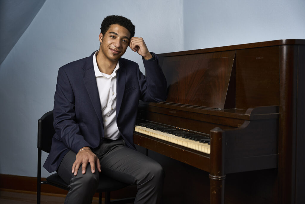 portrait of student Elijah Darden at a piano