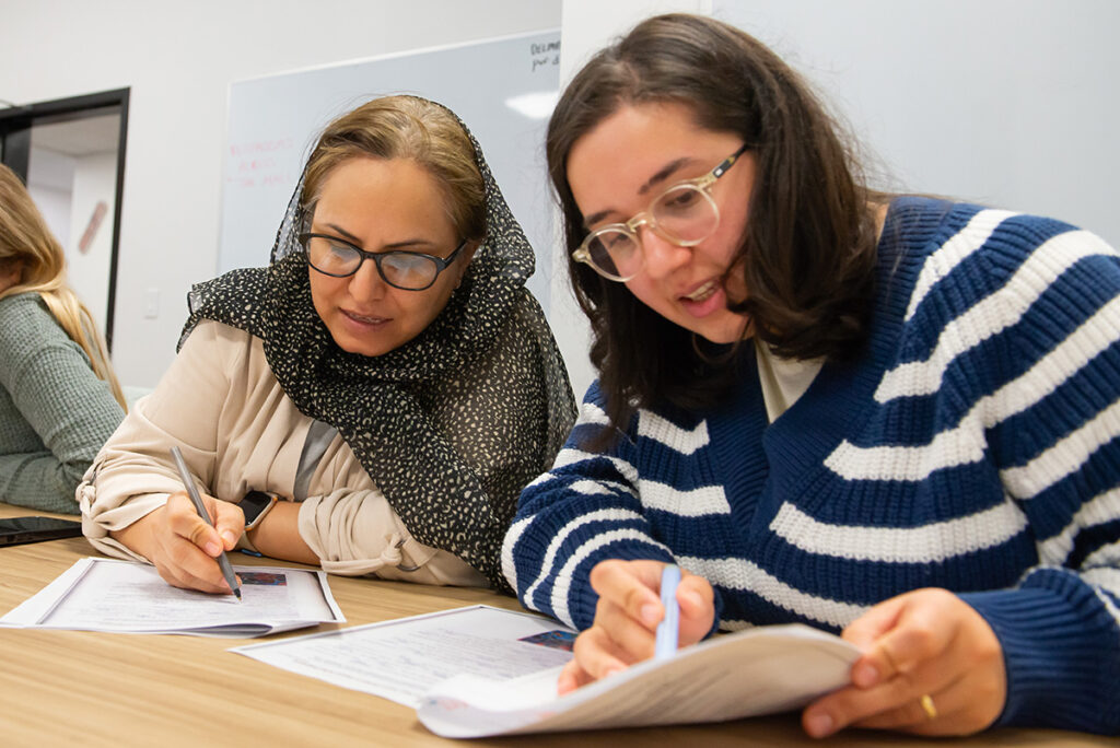 two students work together on a worksheet