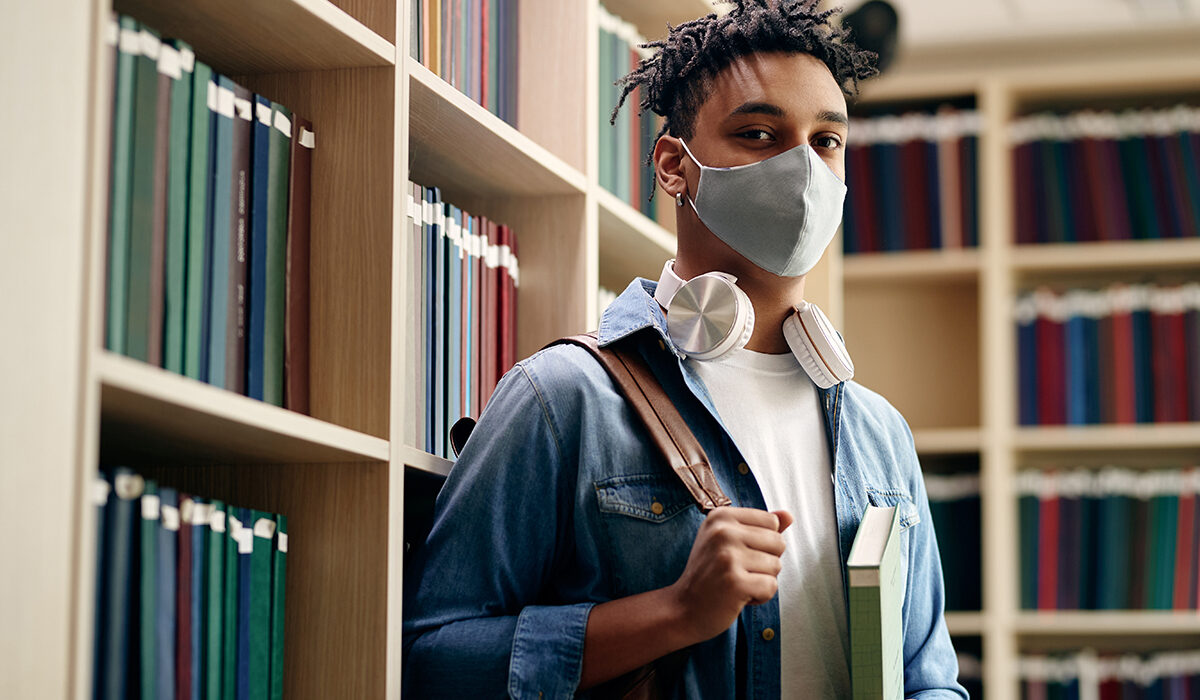 African American college student wearing a face mask