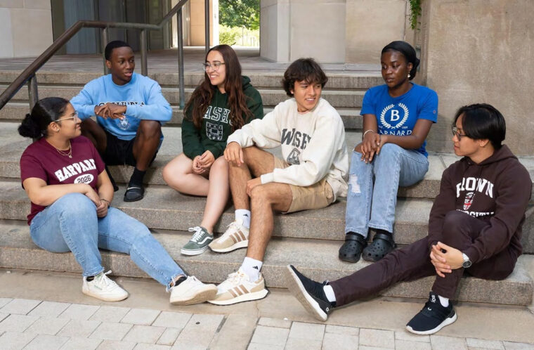 group of students chats on steps