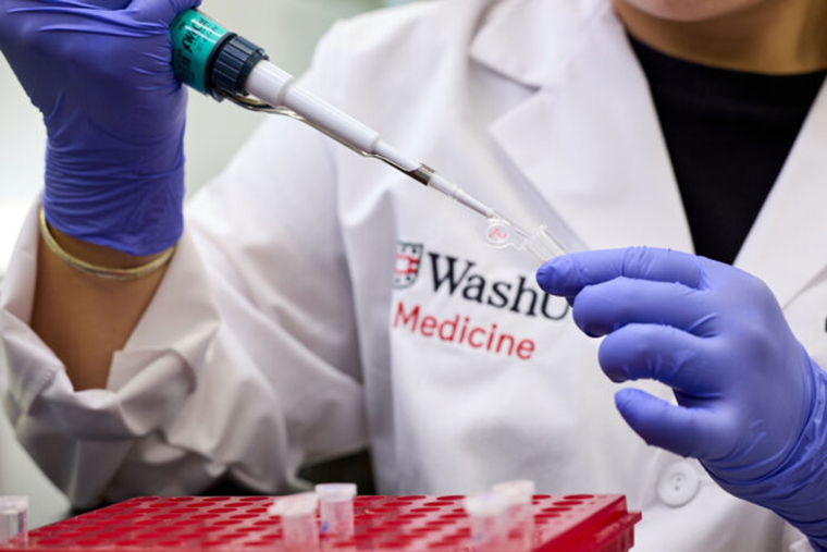 WashU Medicine researcher in lab coat