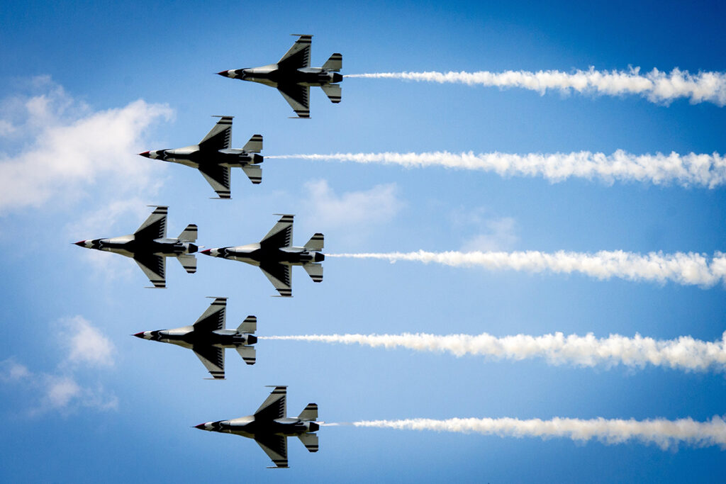 six jets move horizontal through the sky