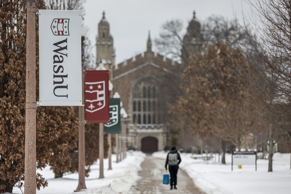 WashU banners along a trail leading to Graham Chapel on a snowy day