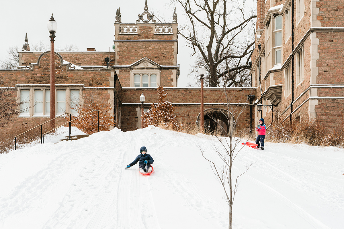 Children sled down a hill