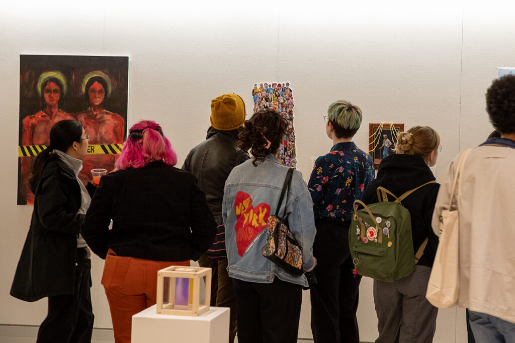 Students look at art in a gallery