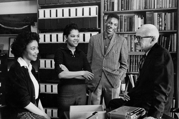 Dean Benjamin Youngdahl (right) meets with students in the late 1940s. Under his leadership, the Brown School made good on its commitment to social justice and took the historic step in 1948 of becoming the first school at WashU to admit Black students.