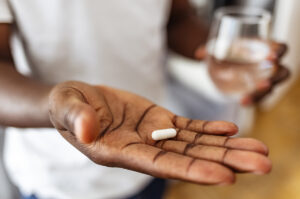 a man holding a pill