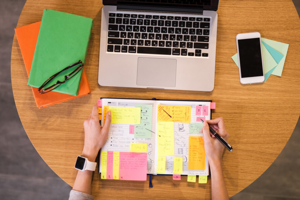 a photo of a scheduling calendar and laptop