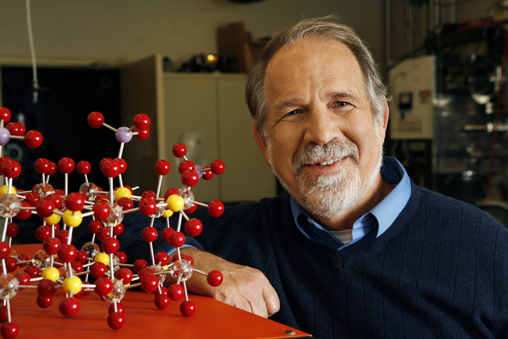 John Gleaves posing with a molecular model