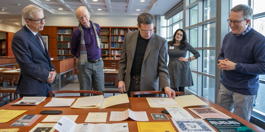 Howard Coale (center), the son of Joan Coale and donor of his mother's decades-long correspondence with Howard Nemerov, lays out the collection at Olin Library with (from left) Alex Nemerov, Howard's son; Vincent Sherry, the Howard Nemerov Professor in the Humanities in Arts & Sciences; and Joel Minor, Joel Minor, curator of the Modern Literature Collection and Manuscripts.