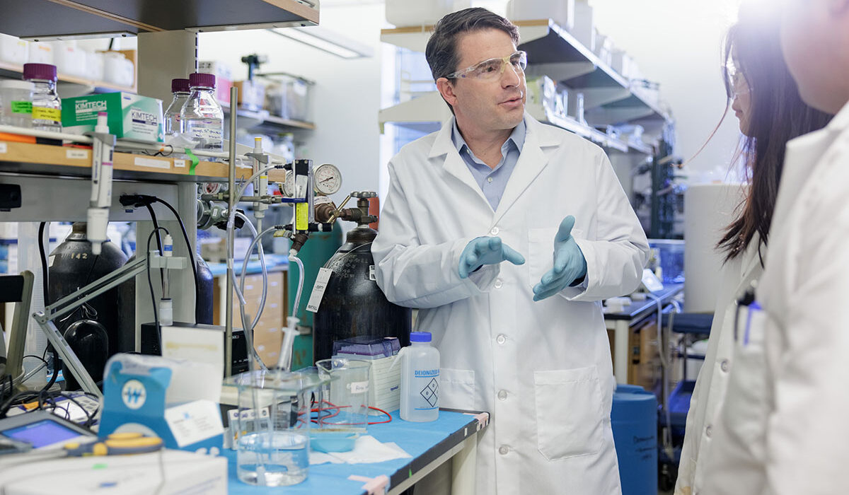 a man in a lab coat at a lab bench