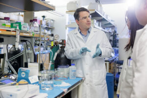 a man in a lab coat at a lab bench