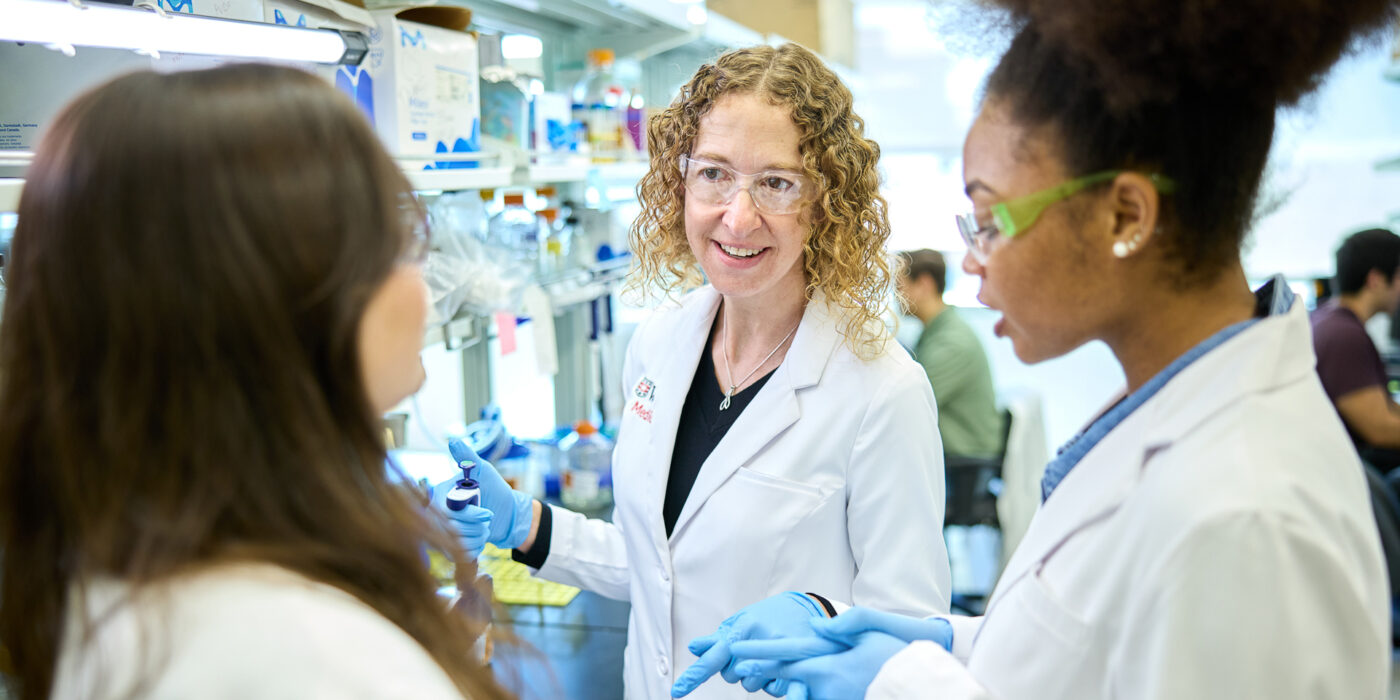 Christina Stallings, PhD (center), works with Kate Wardenburg (left), an MD/PhD student in the Medical Scientist Training Program, and Ananda Rankin, a graduate student in the Roy and Diana Vagelos Division of Biology & Biomedical Sciences, in the Stallings lab at the Steven & Susan Lipstein BJC Institute of Health. (Photo: Matt Miller/WashU Medicine)