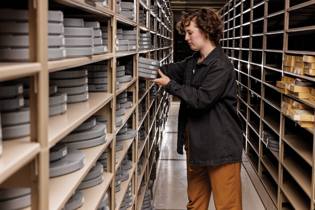 Lydia Creech, a project film preservationist, is among those working in the Film & Media Archive on cataloging and preserving media assets, including 3,500 cans of film, more than 11,000 videotapes and more than 2,000 audio items. (Photo: Whitney Curtis/WashU)