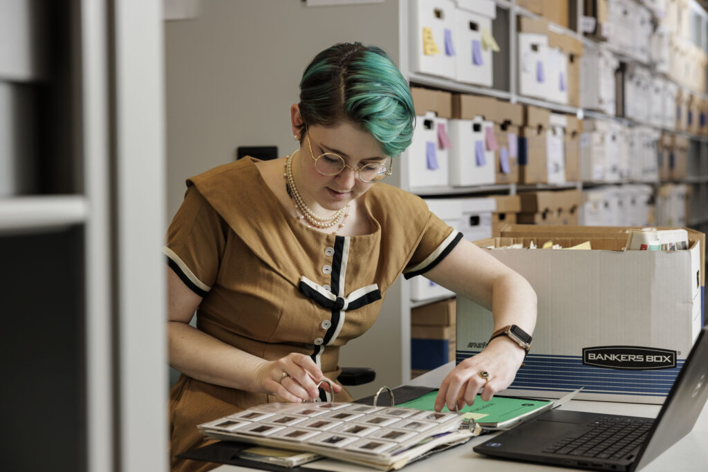 Esther Gabriel, an accessioning archivist, is among those who have been sorting and cataloging 440 boxes of paper assets over the last four years. Recently, the Film & Media Archive finished creating a finding aid of the boxes and folders of paper (their scope and contents) that is now available for researchers. (Photo: Whitney Curtis/WashU)