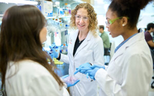 Christina Stallings, PhD (center), works with Kate Wardenburg (left), an MD/PhD student in the Medical Scientist Training Program, and Ananda Rankin, a graduate student in the Roy and Diana Vagelos Division of Biology & Biomedical Sciences, in the Stallings lab at the Steven & Susan Lipstein BJC Institute of Health. (Photo: Matt Miller/WashU Medicine)