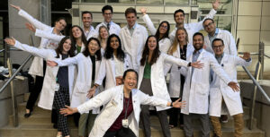 Jennifer Yu (center front) and the most recent class of general surgery interns during orientation in June 2024. Yu is an example of an alum who has built a professional life at WashU after earning degrees here.