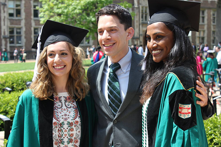 Bono with two graduating seniors who served as teaching assistants for his “Science of Happiness” course in 2016.