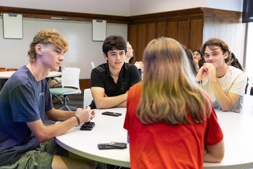 students sitting in a circle and listening to one another
