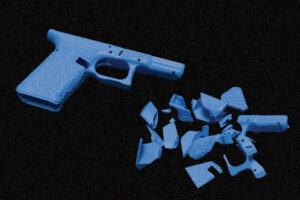 a plastic gun and chunks of plastic show how that gun can be broken