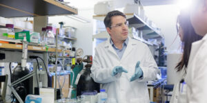 a man in a lab coat at a lab bench