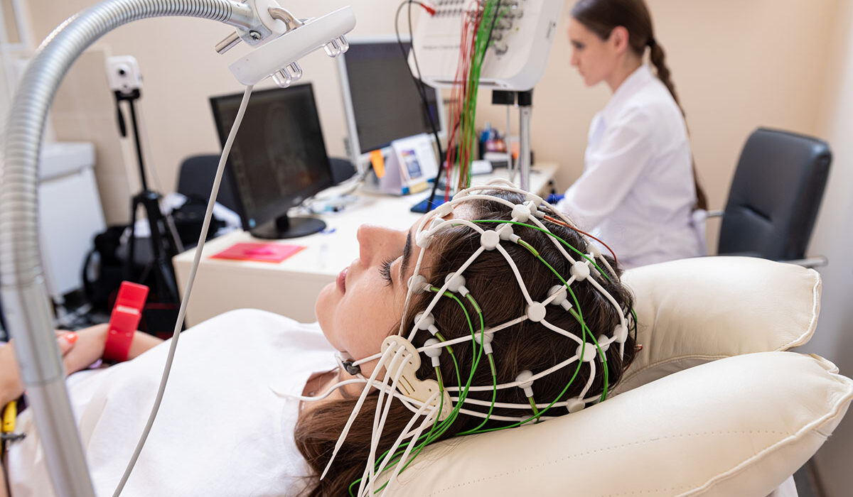 a woman in a cap to measure brain activity