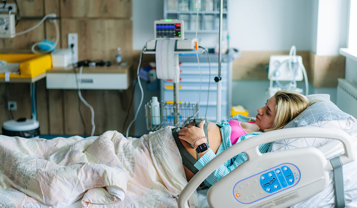 a pregnant woman in a delivery room bed