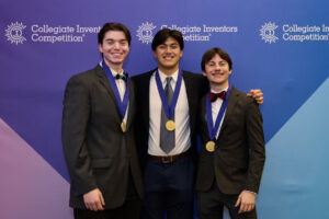 three young men pose for a photo