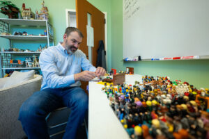 A man with a table full of legos