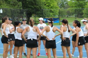 WashU Tennis coach Paige Madara with team.