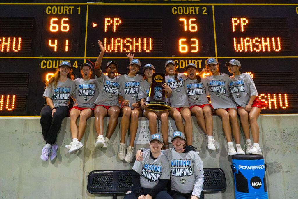 "You told us we could do this from the beginning." Madara (front right) and assistant coach Erin Swaller (front left) posed with the national champions and WashU's latest national championship trophy last May in Claremont, California. (Photo: Courtesy of WashU Athletics)