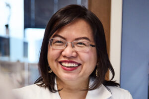 a middle aged woman with brown hair smiling.