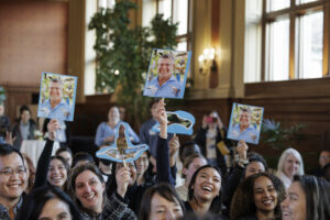 Colorful bird signs lift above the crowd at Steensma’s installation ceremony, honoring the scholar who has authored three field guides on avian life.