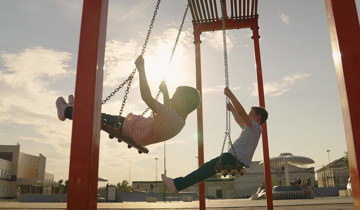 kids swinging at a playground