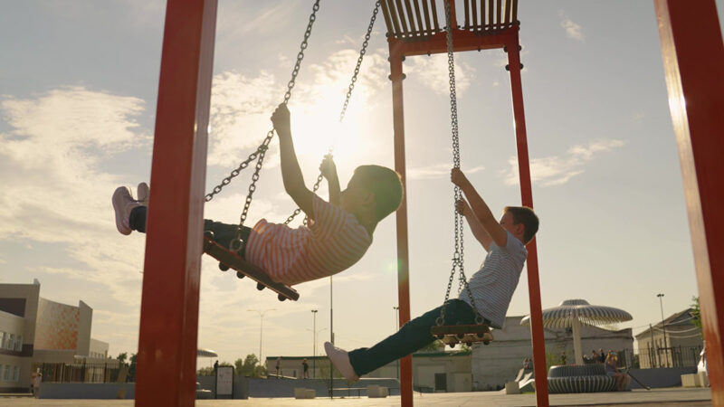 kids swinging at a playground
