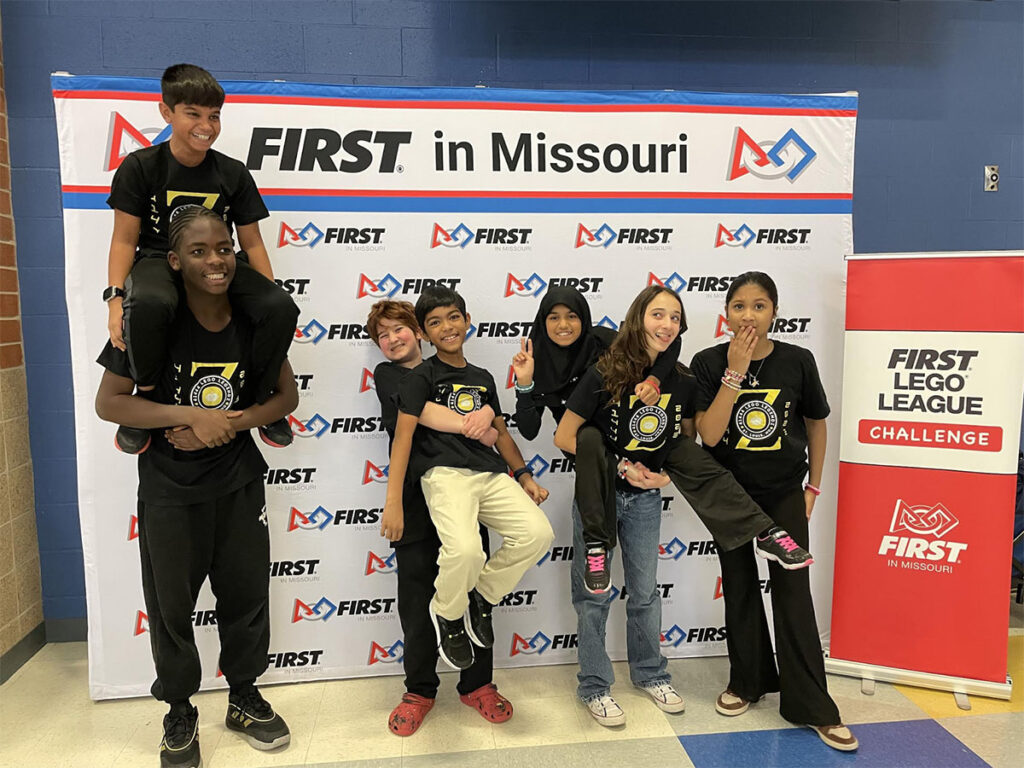 group photo of kids making silly faces after winning a competition.