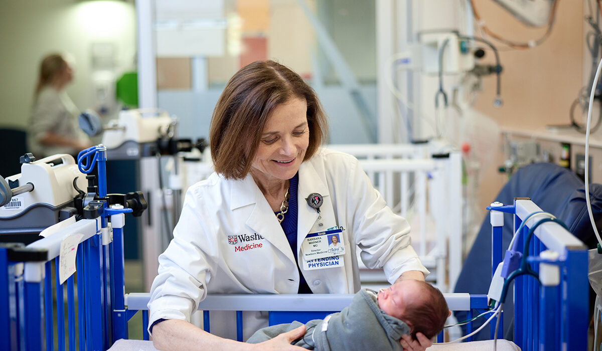 WashU Medicine neonatologist Barbara Warner with a premature baby