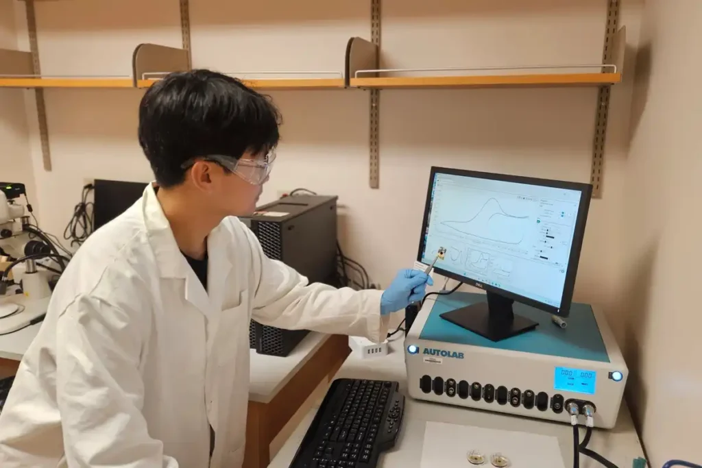 researcher looks at a computer