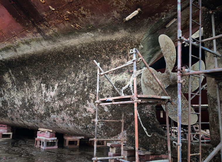 a dirty ship hull covered in barnacles